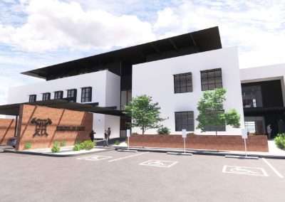 This is a rendering of a modern two-story building with a parking lot, featuring people, accessible parking spaces, and a horse sculpture on the wall.